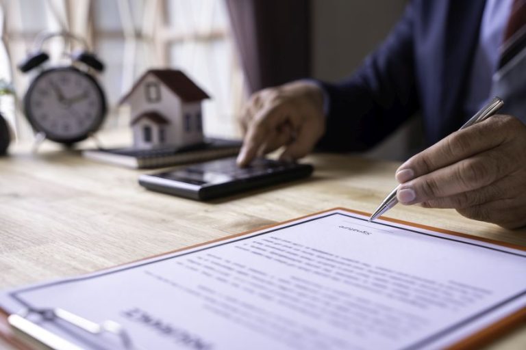 loan officer reviewing mortgage application to avoid unqualified borrower meetings